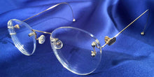 Load image into Gallery viewer, Side view of Signature Rimless gold eyeglasses with P3 lenses
