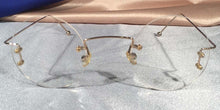 Load image into Gallery viewer, Front view of Duolettes gold rimless eyeglasses with round lenses
