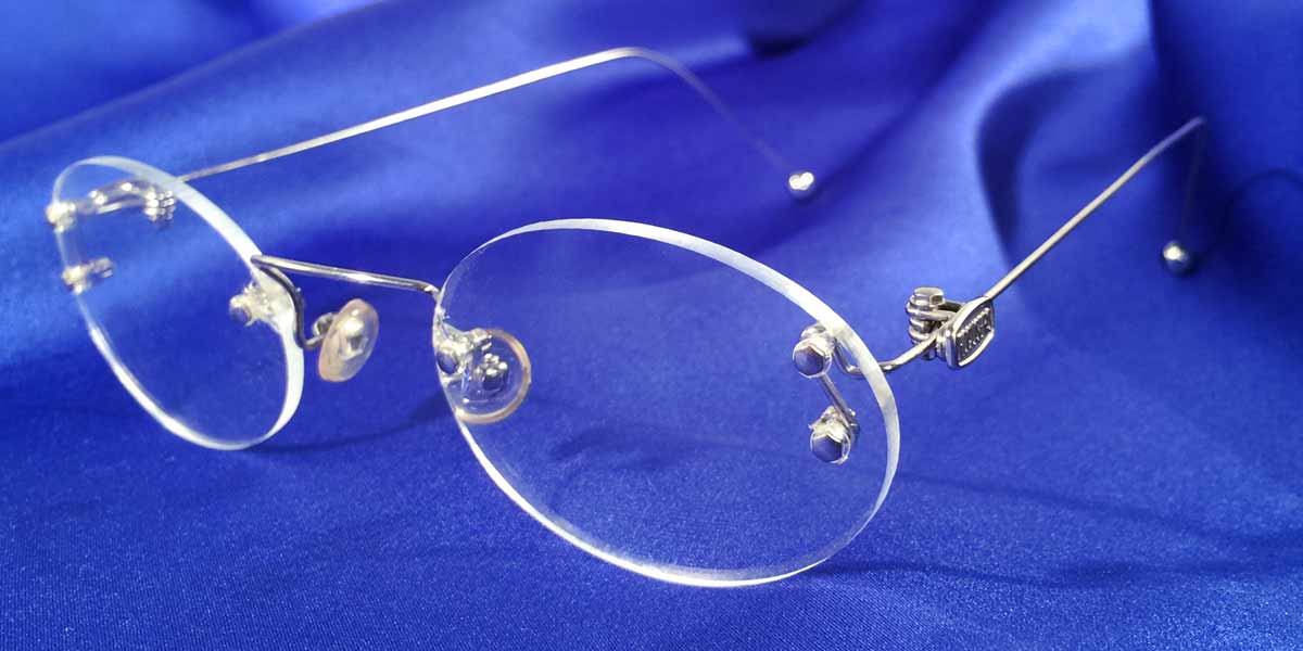Side view of Signature Rimless silver eyeglasses with oval lenses