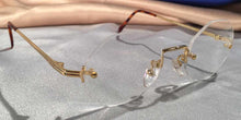 Load image into Gallery viewer, Side view of Traditionals Rimless gold metal eyeglasses with octagon lenses
