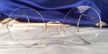 Load image into Gallery viewer, Front view of Tuxedo Cable Rimless silver metal eyeglasses with round lenses
