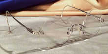 Load image into Gallery viewer, Side view of Tuxedo Cable Rimless silver metal eyeglasses with round lenses
